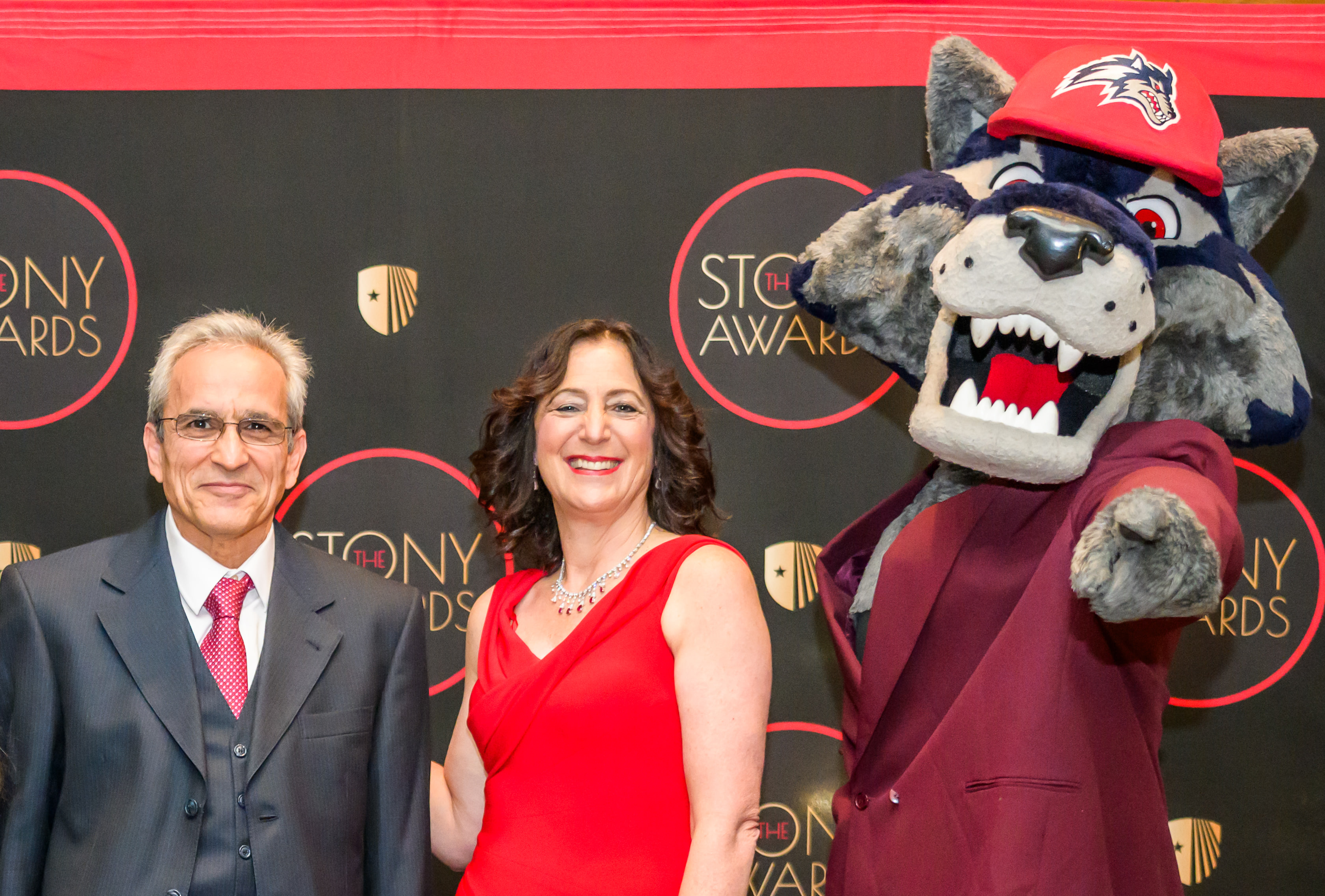 Esmaili poses with SBU President and Wolfie (the Seawolf Mascot)