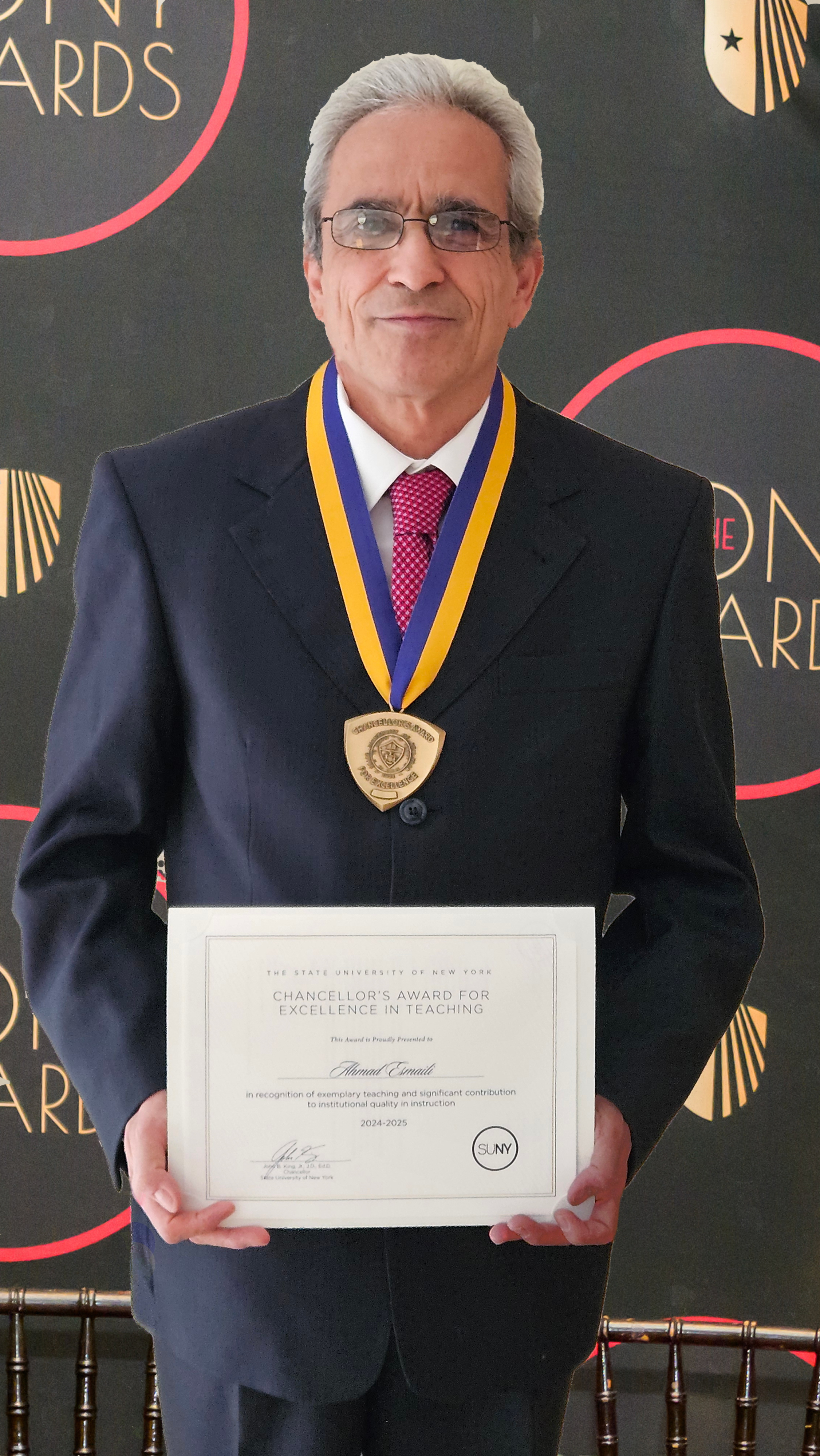 Esmaili poses wearing a medal and holding a certificate