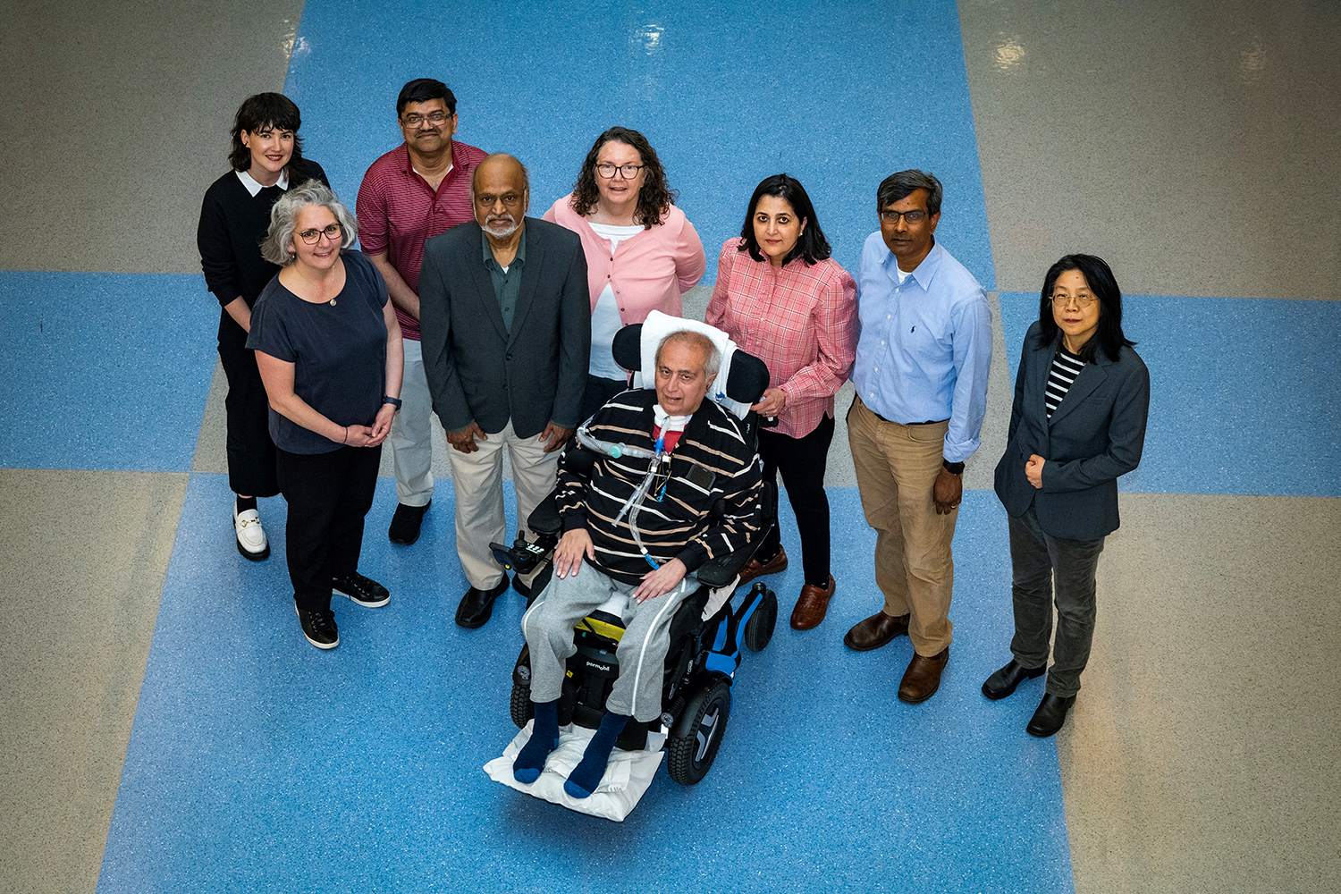 Members of the CART research team assembled in the New Computer Science building at Stony Brook. Vibha Mullick, and her husband, ALS patient Anuraag Mullick, in the center. Back row, from left: Clare Whitney, Nilanjan Chakraborty, Theresa Imperato, C.R. Ramakrishnan, and Wei Zhu. Front row, from left, are Maria Milazzo and I.V. Ramakrishnan. Credit: John Griffin/Stony Brook University