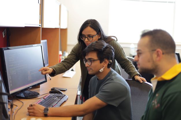 Pictured: Prof. Shubham Jain (standing) with PhD students  Tanmay Srivastava, and John Murzaku