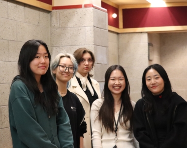 Five female students pose together for a photo.