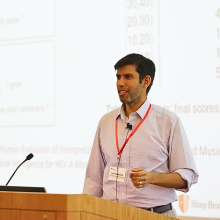 Lav Varshney stands behind a podium, giving a talk