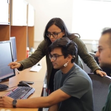 Pictured: Prof. Shubham Jain (standing) with PhD students  Tanmay Srivastava, and John Murzaku